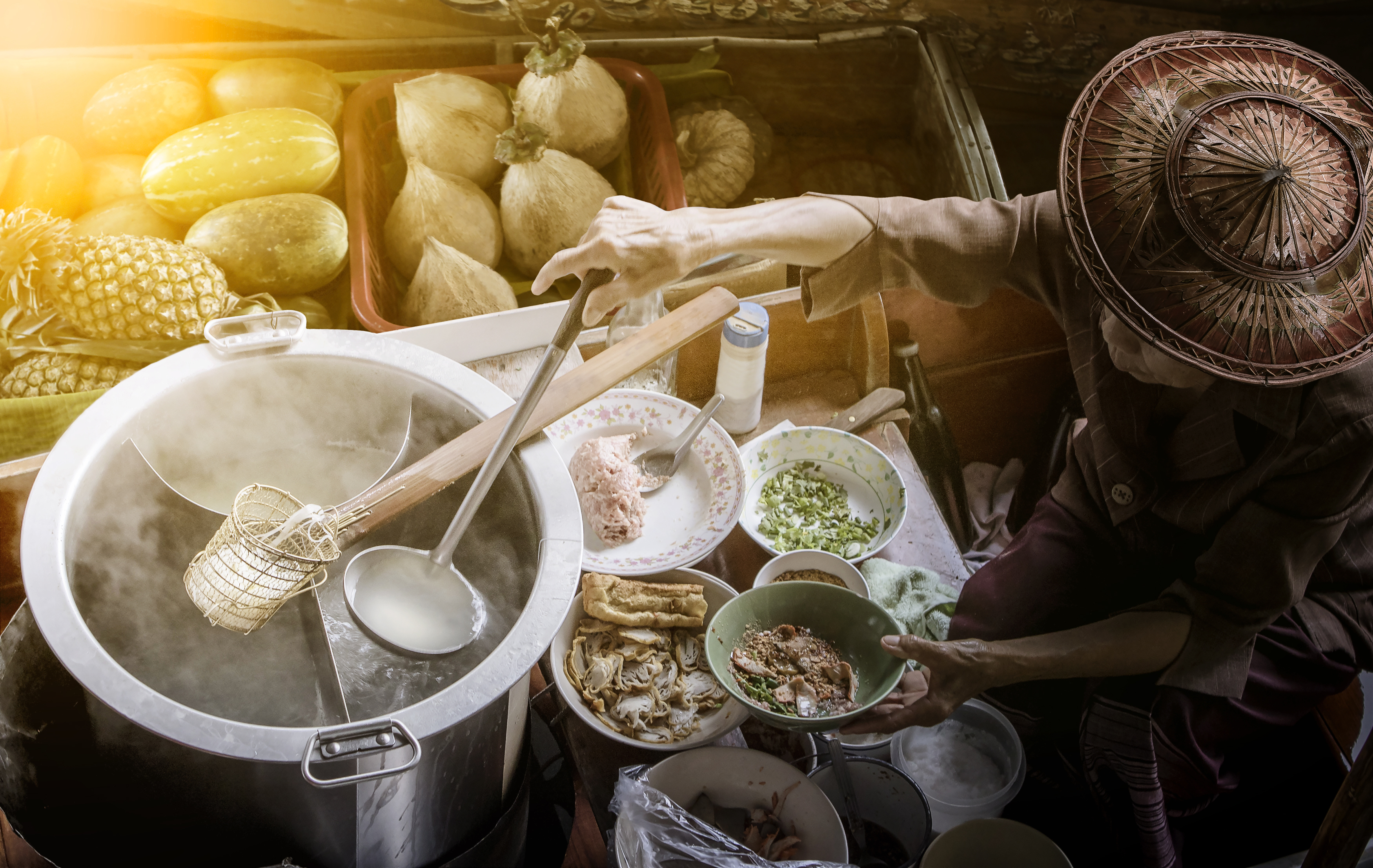 thai noodle food making on floating boat in floating market thailand